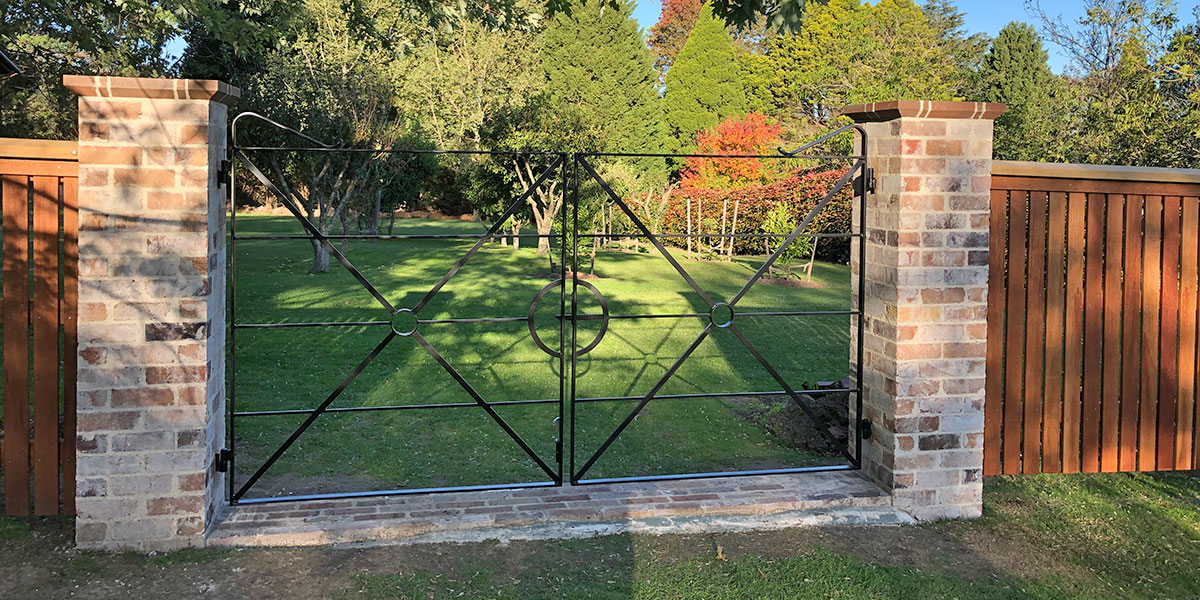 Gateway is constructed using recycled brick gate columns and customised iron gates